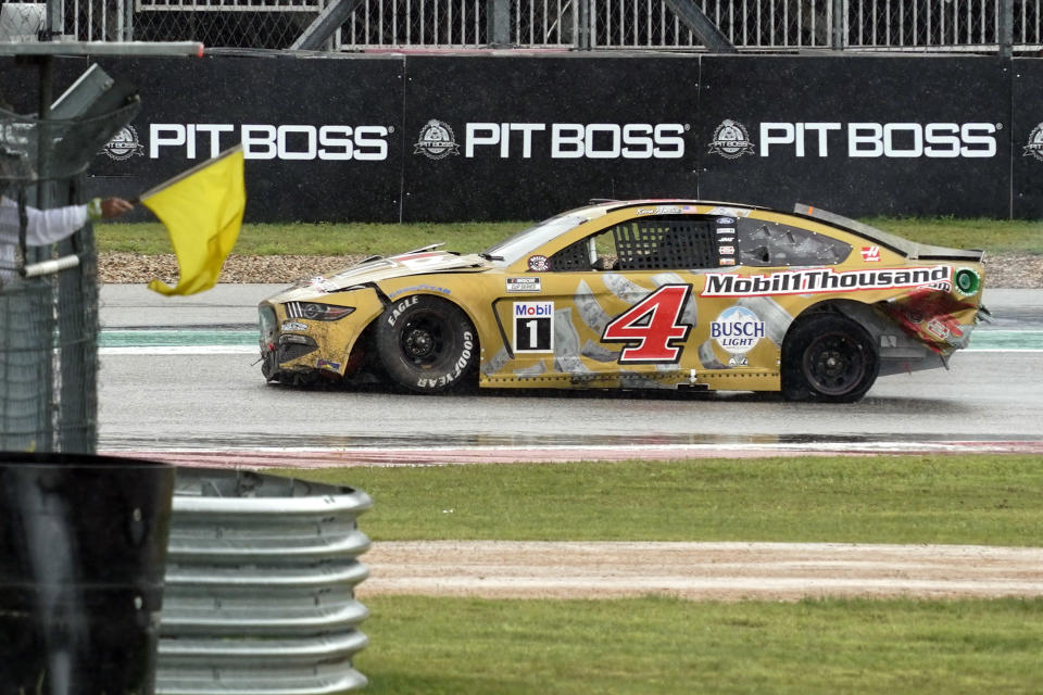 Kevin Harvick (4) drives past a yellow flag in Turn 15 after a crash during a NASCAR Cup Series auto race at Circuit of the Americas in Austin, Texas, Sunday, May 23, 2021. (AP Photo/Chuck Burton)