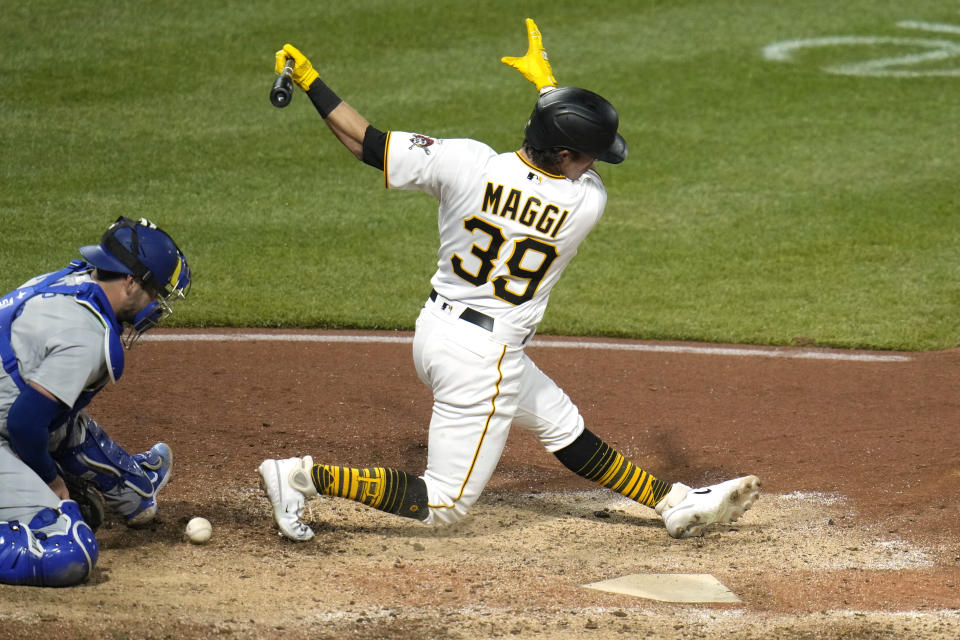 Pittsburgh Pirates' Drew Maggi (39) fouls off a third strike, and Los Angeles Dodgers catcher Austin Wynns doesn't hang onto the ball, in his major league debut during the eighth inning of an 8-1 win over the Los Angeles Dodgers in a baseball game in Pittsburgh, Wednesday, April 26, 2023. Maggi ran to first and was out on the play. (AP Photo/Gene J. Puskar)