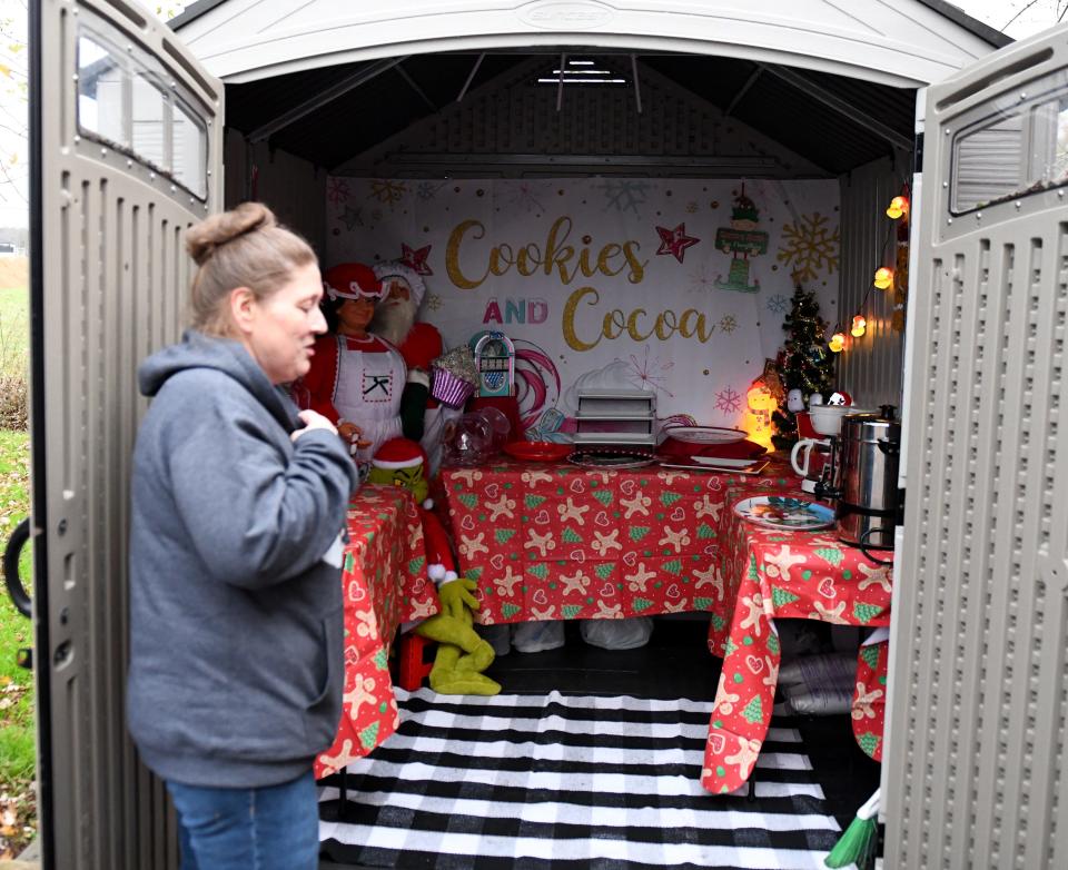 Marsha Newtown shows where visitors will be able to recieve free snacks and drinks at the combined Christmas Town and the Nick Family Christmas Light Show at 6685 Friendship Road Nov. 15, 2022, in Pittsville, Maryland.