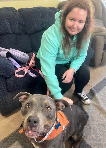 <p>Animal Resource Center</p> Kaitlyn with Ella the dog, who is wearing an orange bandana that once belonged to Kaitlyn's late pet