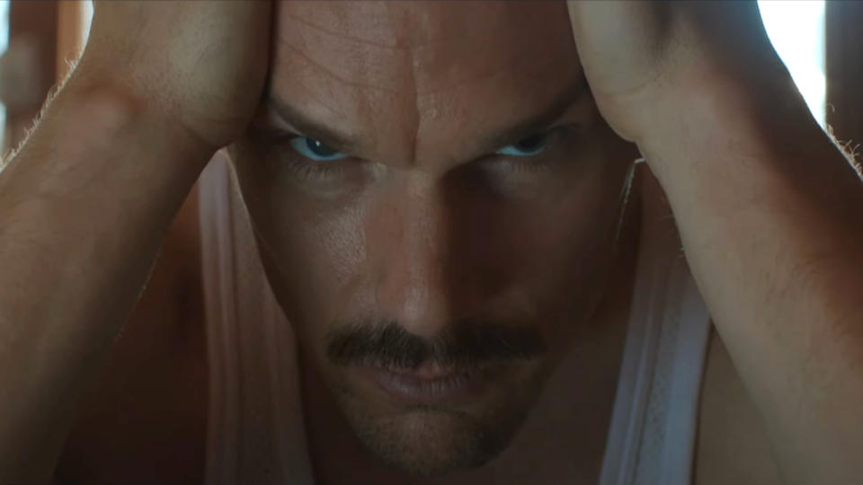 Ethan Hawke stares menacingly while holding his head in Predestination.