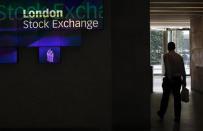 A man walks through the lobby of the London Stock Exchange August 5, 2011. REUTERS/Suzanne Plunkett