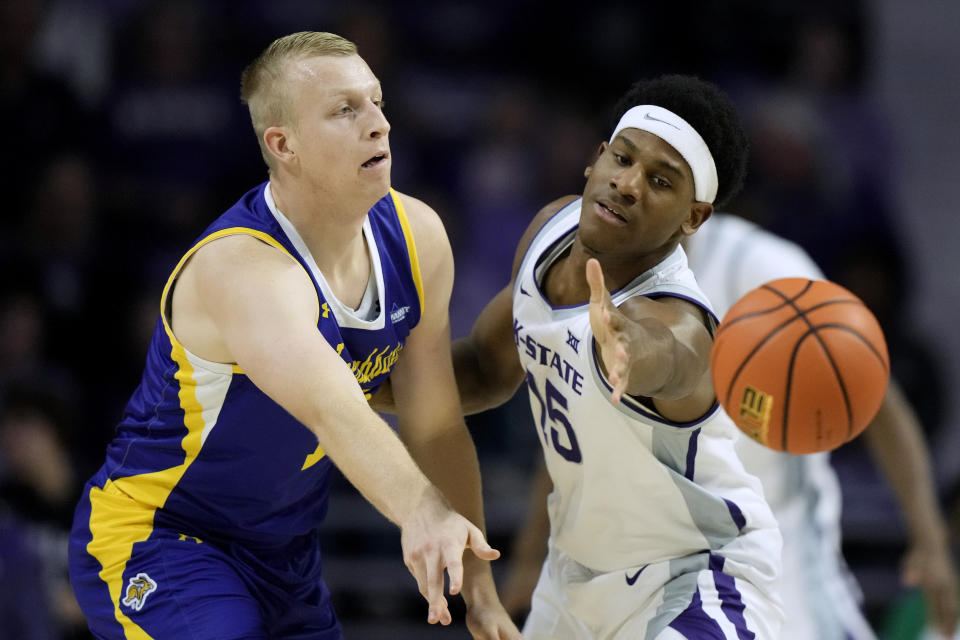 South Dakota State forward Matthew Mors, left, passes the ball under pressure from Kansas State forward Taj Manning during the first half of an NCAA college basketball game Monday, Nov. 13, 2023, in Manhattan, Kan. (AP Photo/Charlie Riedel)