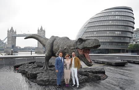 Cast members (L to R) Chris Pratt, Bryce Dallas Howard, and Jeff Goldblum pose in front of a model dinosaur during a photocall to promote the forthcoming film 'Jurassic World: Fallen Kingdom' in London, Britain, May 24, 2018. REUTERS/Toby Melville