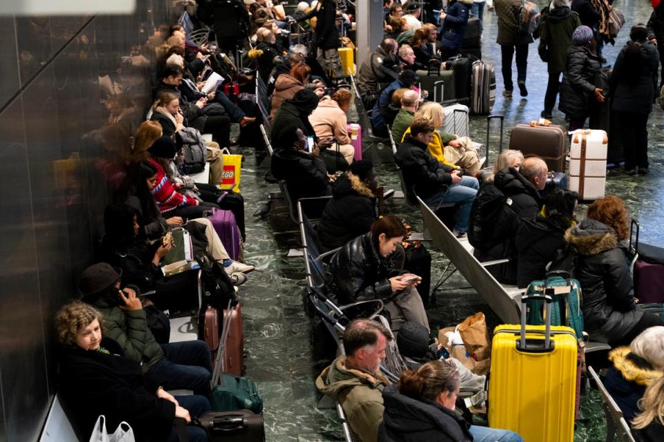 Passengers at Euston station, London, following train delays as Storm Isha has brought severe disruption to rail services. (PA)