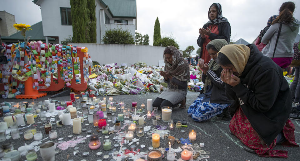 Mourners break down at a memorial for the victims. Source: AP