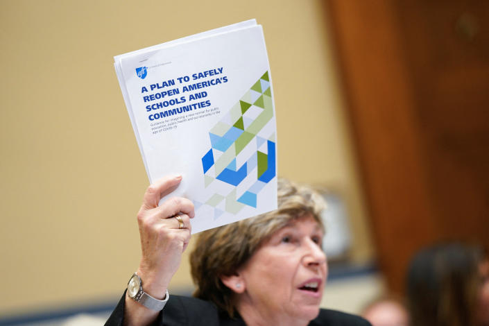 Randi Weingarten holds up a sheaf of papers saying: A Plan to Safely Reopen America&#39;s Schools and Communities.