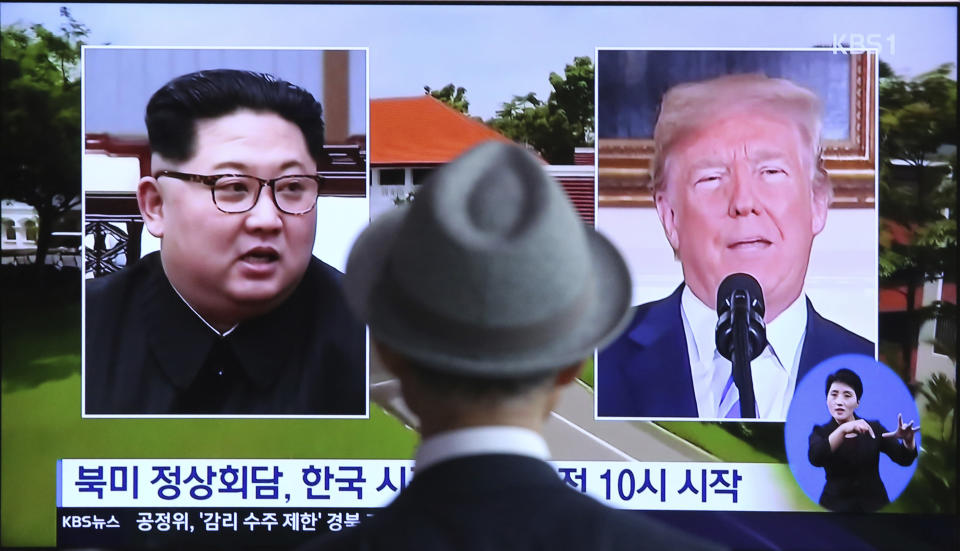 In this June 11, 2018, file photo, a man watches a TV screen showing file footage of U.S. President Donald Trump, right, and North Korean leader Kim Jong Un during a news program at the Seoul Railway Station in Seoul, South Korea. Trump and Kim are planning a second summit in the Vietnam capital of Hanoi, Feb. 27-28. The signs read: " Summit between the United States and North Korea." (AP Photo/Ahn Young-joon, File)