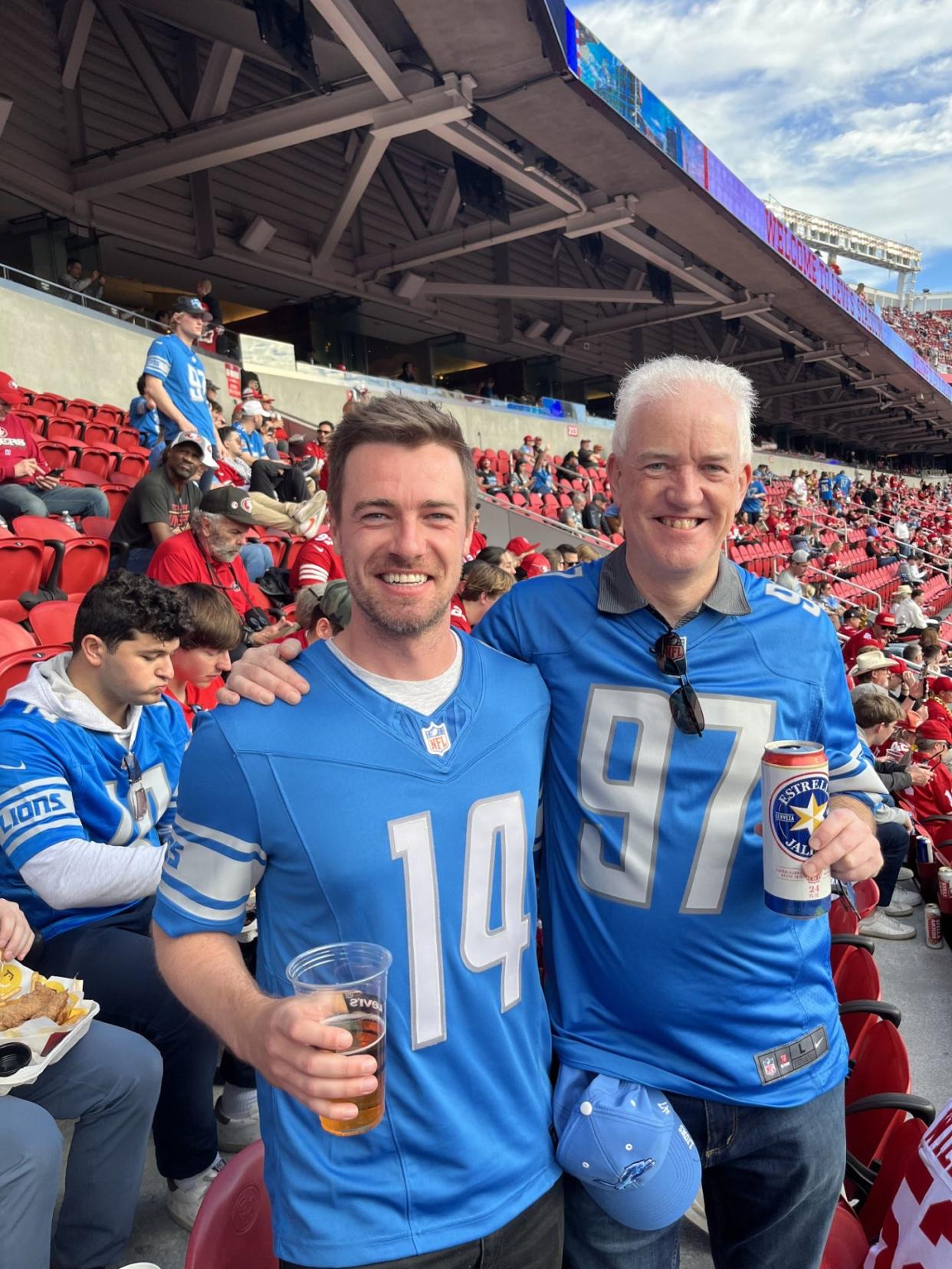 Tim Evans, left, and his son, Gareth, get ready for the NFC championship game in the stands in Levi's Stadium in Santa Clara, California, after traveling from London.