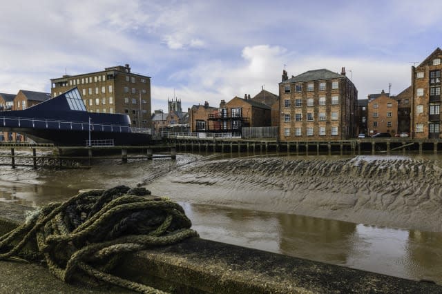 River Hull with bridge, flats, and church on the horizon.