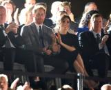 <p>Meghan perfects the art of "applauding while holding on to your significant other" with aplomb.</p>