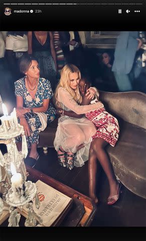 <p>Madonna/Instagram</p> Madonna hugs one of her twin daughters, Stella and Estere, at her 65th birthday celebration.