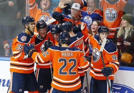 Feb 21, 2019; Edmonton, Alberta, CAN; The Edmonton Oilers celebrate after the winning goal by forward Connor McDavid (97) in overtime against the New York Islanders at Rogers Place. Mandatory Credit: Perry Nelson-USA TODAY Sports