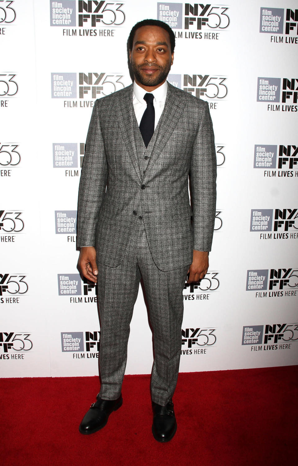 <p>Chiwetel Ejiofor, obviously a big fan of plaid suits, stuck with his favorite pattern on the red carpet in a gray one with a vest, white collared shirt, and black tie. </p>