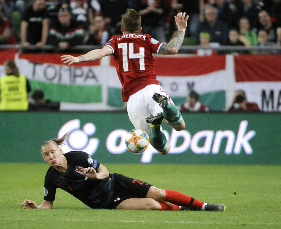 Gergo Lovrencsics, right, of Hungary and Domagoj Vida of Croatia in action during the UEFA EURO 2020 qualifying soccer match between Hungary and Croatia in Groupama Arena in Budapest, Hungary, Sunday, March 24, 2019. (Balazs Czagany/MTI via AP)