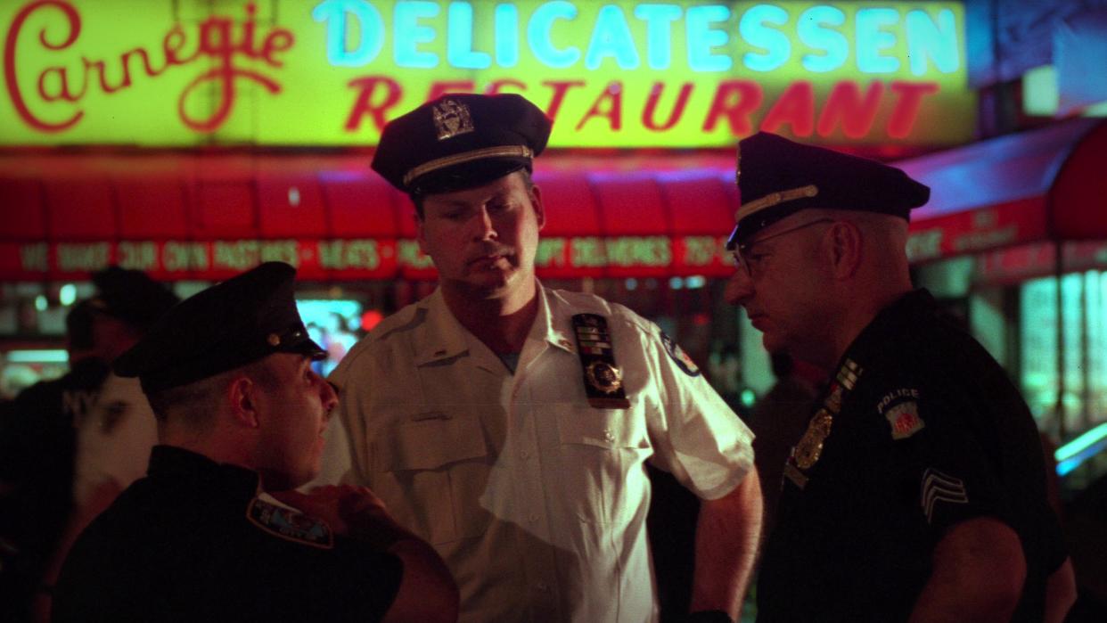  Still image of police in front of the Carnegie Deli in Homicide New York. 