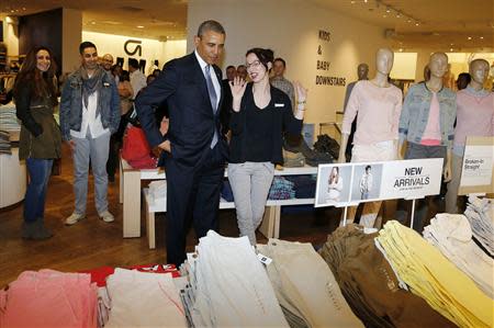 U.S. President Barack Obama looks for gifts for his family with saleswoman Susan Panariello after stopping off at the GAP in New York, March 11, 2014. REUTERS/Larry Downing