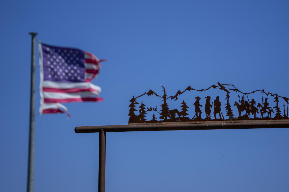 A battered U.S. flag gives backdrop to decoration to an entrance of a residence the morning after a deadly tornado rolled through, Sunday, May 26, 2024, in Valley View, Texas. Powerful storms left a wide trail of destruction Sunday across Texas, Oklahoma and Arkansas after obliterating homes and destroying a truck stop where drivers took shelter during the latest deadly weather to strike the central U.S. (AP Photo/Julio Cortez)