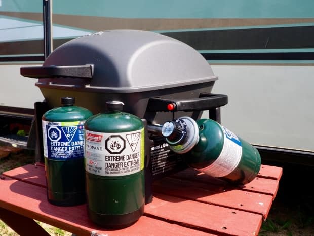 The 16-ounce steel canisters of propane, used by many campers for portable stoves and barbecues, are in short supply.   (Therese Kehler/CBC News - image credit)