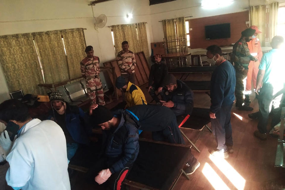 Evacuees (left) rest after receiving first aid at the ITBP Matli helipad station on October 5, 2022, after being airlifted during a rescue operation for 26 missing climbers struck by an avalanche in the northern state of Uttarakhand.  / Credit: -/Indo-Tibetan Border Police (ITBP/AFP via Getty Images