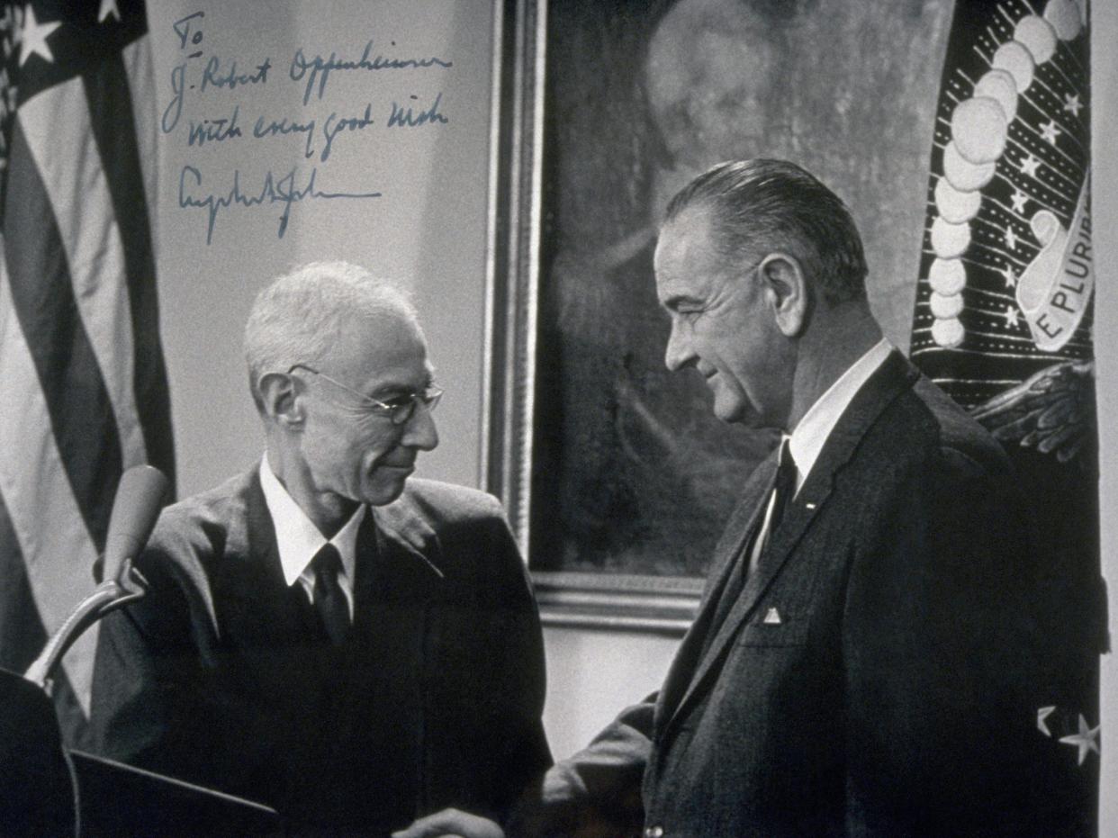 President Lyndon B. Johnson shakes hands with physicist J. Robert Oppenheimer at a ceremony presenting him with the Enrico Fermi Award in 1963.