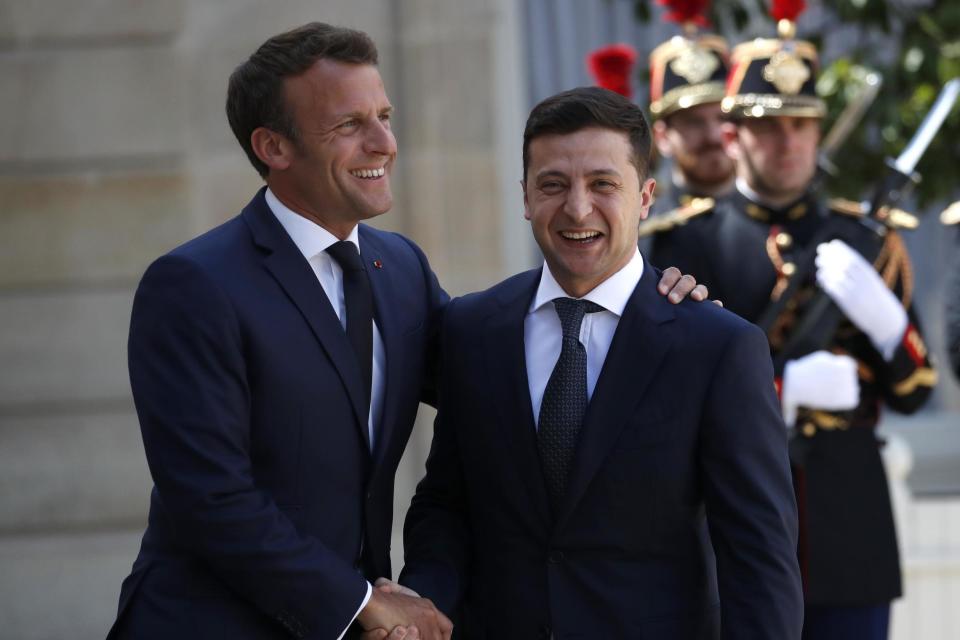 French president Emmanuel Macron (left) is accused of courting business rather than fighting climate change (AP)