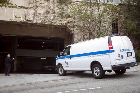 An LA County Coroner's Office van pulls into the rear entrance of the Sunset Marquis hotel where U2 tour manager Dennis Sheehan was pronounced dead in his hotel room, according to local media, in West Hollywood, California May 27, 2015. REUTERS/Patrick T. Fallon