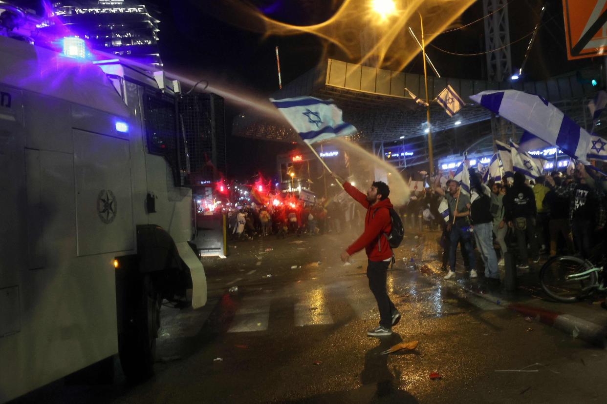 Israeli security forces use water canons to disperse protesters during ongoing demonstrations in Tel Aviv on March 27, 2023 (AFP via Getty Images)