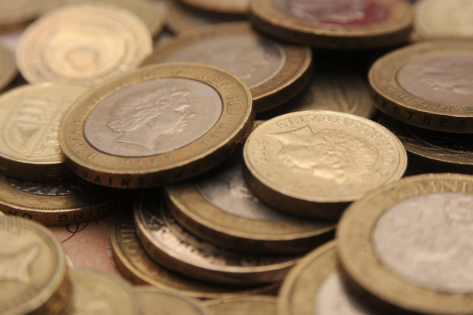 A selection of one pound coins, two pound coins and bank notes