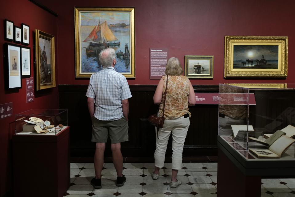 Visitors to the newly opened A Singularly Marine & Fabulous Produce: The Cultures of Seaweed at the New Bedford Whaling Museum take in some of the many various art forms depicting seaweed.
