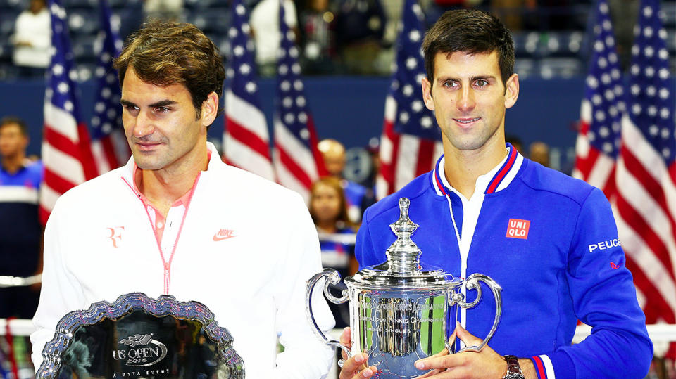 Novak Djokovic stands next to Roger Federer after winning the US Open 6-4, 5-7, 6-4, 6-4.