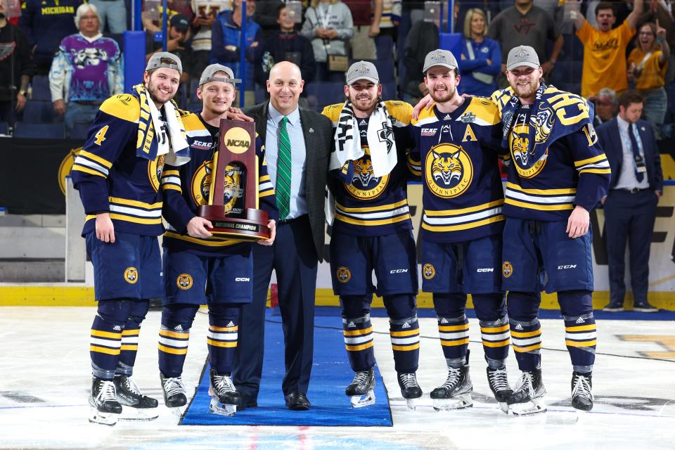 Quinnipiac defenseman Zach Metsa (23) holds the national champion trophy after beating Minnesota in the national championship game of the 2023 Frozen Four college ice hockey tournament at Amalie Arena.