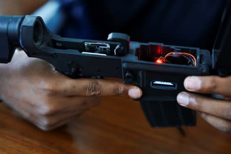 Melvic Smith, CEO of Dimensional Weapons Systems, holds an early prototype weapon at the company's office in College Park