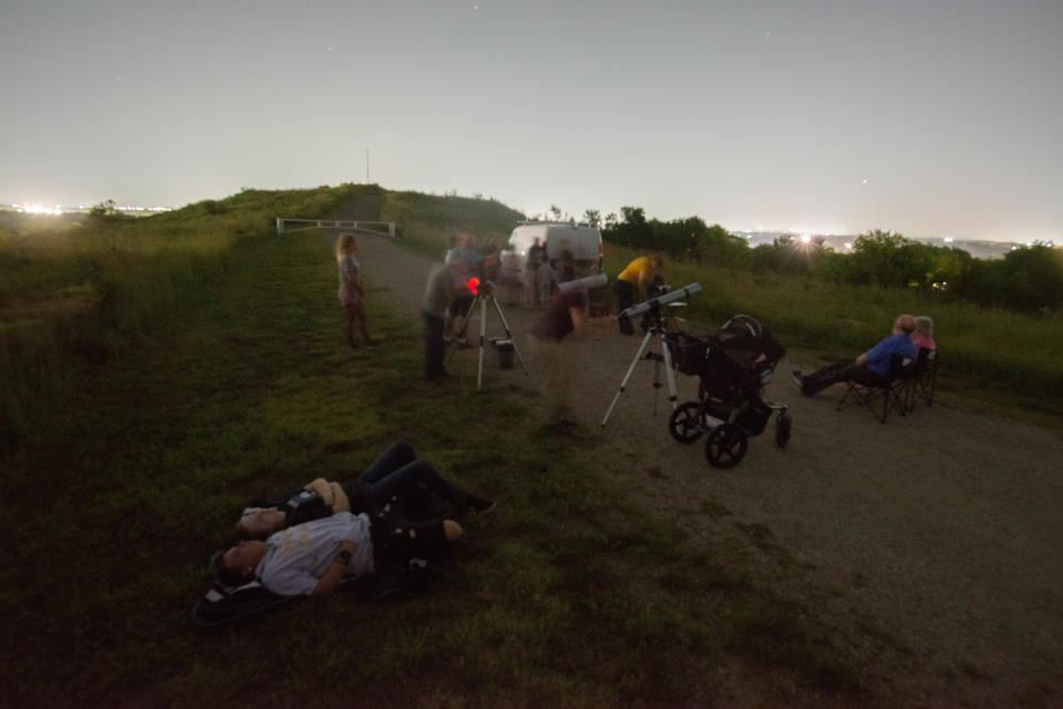 Local residents gather with telescopes, blankets and folding chairs atop Burnett's Mound to catch a glimpse of Saturn's rings during Shawnee County Parks and Recreation's "Ring In Saturn" event.