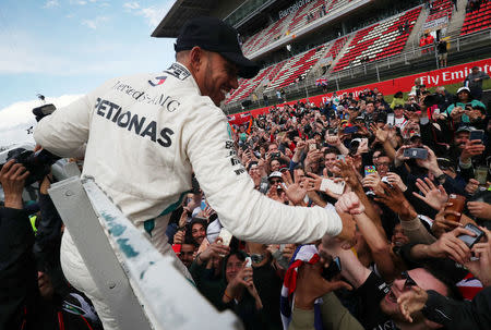 Formula One F1 - Spanish Grand Prix - Circuit de Barcelona-Catalunya, Barcelona, Spain - May 13, 2018 Mercedes’ Lewis Hamilton celebrates with fans after winning the race REUTERS/Albert Gea