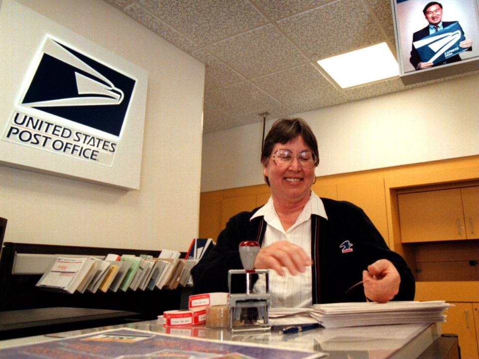 A postal worker wears a cardigan in 1998