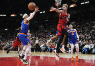 Toronto Raptors guard Gradey Dick (1) passes the ball past New York Knicks guard Josh Hart (3) during the first half of an NBA basketball game Wednesday, March 27, 2024, in Toronto. (Frank Gunn/The Canadian Press via AP)