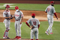 Philadelphia Phillies manager Joe Girardi (25) talks to shortstop Didi Gregorius (18) after relieving Philadelphia Phillies relief pitcher Deolis Guerra (57) after Guerra allowed a three-run home run to New York Yankees Gio Urshela during the sixth inning of a baseball game, Monday, Aug. 3, 2020, at Yankee Stadium in New York. Phillies second baseman Scott Kingery (4) is at left. (AP Photo/Kathy Willens)