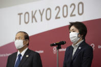 Tokyo 2020 Organizing Committee President Seiko Hashimoto, right, speaks to media after a video conference with the IOC executive board on Wednesday, Feb. 24, 2021, in Tokyo. Hashimoto, a former Olympics minister and seven time Olympian, was recently appointed the Tokyo 2020 president after her predecessor Yoshiro Mori quit following a backlash over sexist comments he made at an earlier meeting. (Takashi Aoyama/Pool Photo via AP)