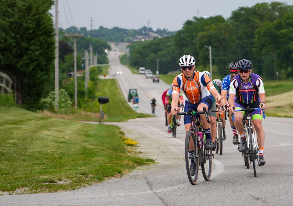 Riders roll out of Des Moines during the RAGBRAI route inspection ride Thursday.