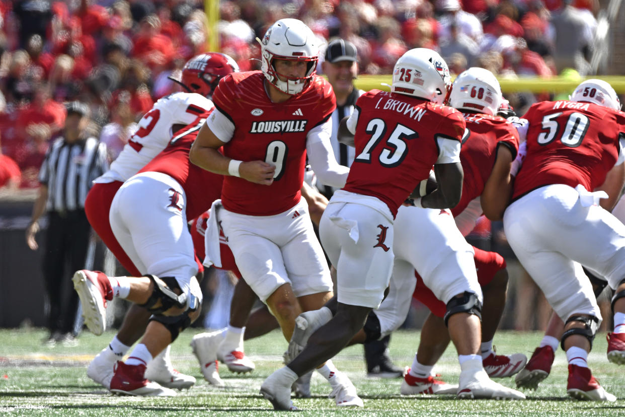 Louisville quarterback Tyler Shough (9) hands the ball off to running back Isaac Brown (25) during the first half of an NCAA college football game against Jacksonville State in Louisville, Ky., Saturday, Sept. 7, 2024. (AP Photo/Timothy D. Easley)