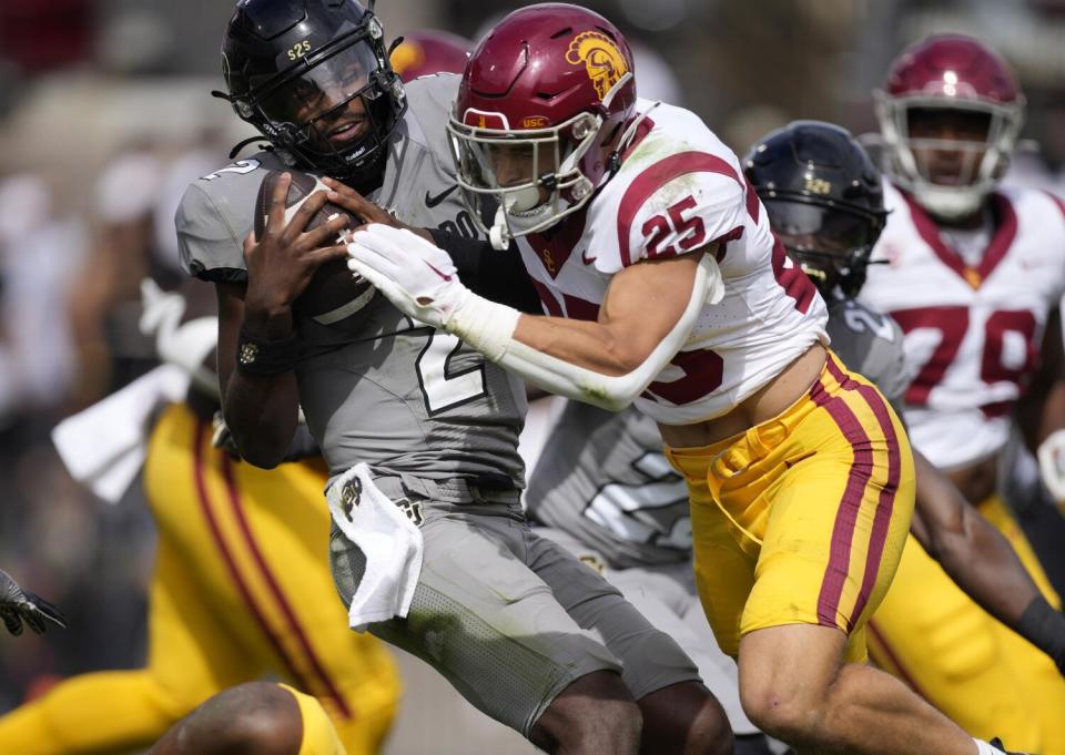 USC linebacker Tackett Curtis tackles Colorado quarterback Shedeur Sanders during the Trojans' win on Sept. 30.