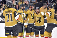 The Vegas Golden Knights celebrate a goal by Jack Eichel, center, against the Anaheim Ducks during the second period of an NHL hockey game Thursday, April 18, 2024, in Las Vegas. (AP Photo/David Becker)