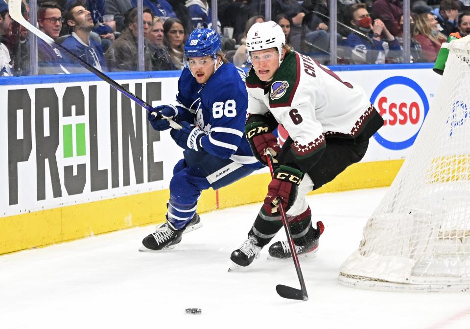Mar 10, 2022; Toronto, Ontario, CAN; Arizona Coyotes defenseman Jakob Chychrun (6) pursues a loose puck ahead of Toronto Maple Leafs forward William Nylander (88) in the first period at Scotiabank Arena.