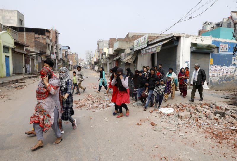 Muslims leave a Hindu dominated locality in a riot affected area after clashes erupted between people demonstrating for and against a new citizenship law in New Delhi