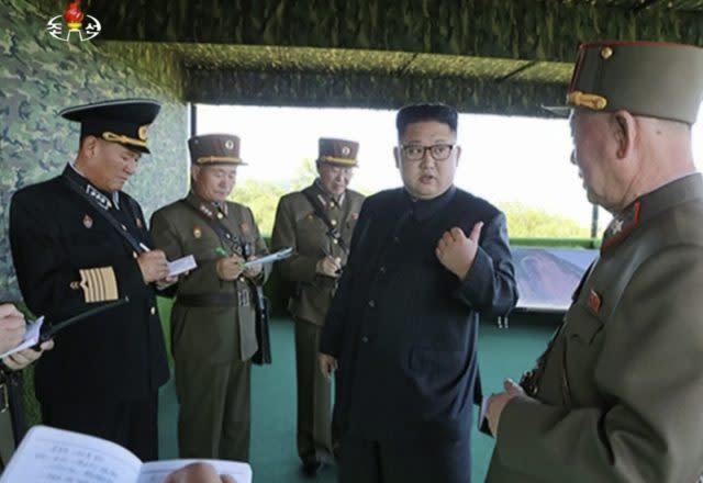 North Korean leader Kim Jong Un, second right, speaks with officials