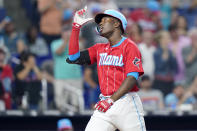 Miami Marlins' Jesus Sanchez gestures skyward as he crosses home plate after hitting a two-run home run in the fourth inning of a baseball game against the New York Mets, Saturday, June 25, 2022, in Miami. (AP Photo/Lynne Sladky)