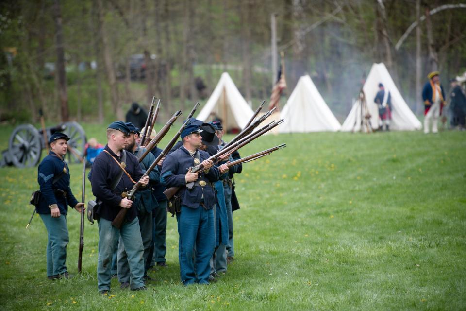 Civil war re-enactors prepare to fire during the Maple Syrup Festival Sunday at Bradys Run Park.