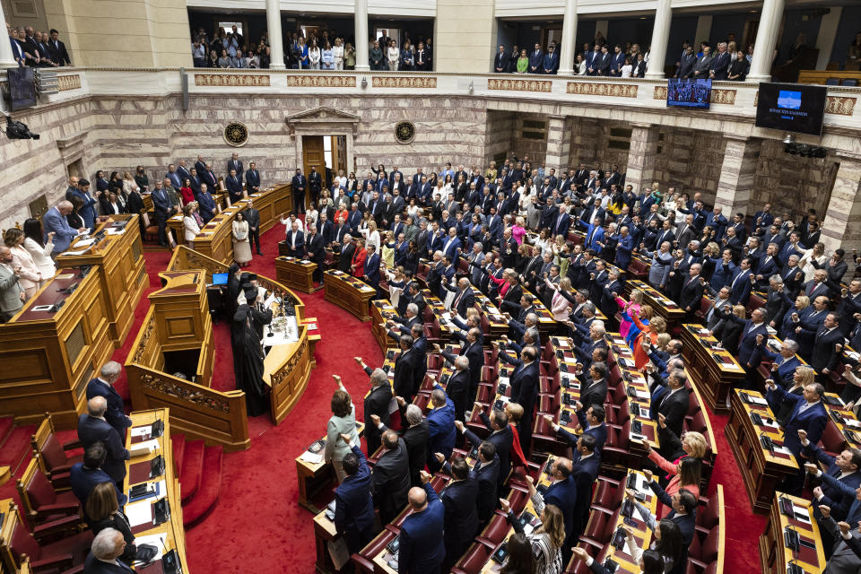 Greek lawmakers take the oath during a swearing in ceremony at the parliament in Athens, Greece, Sunday, May 28, 2023. Newly elected Greek lawmakers were sworn in Sunday, but the Parliament elected on May 21 could be dissolved as early as Monday and a new election campaign start for another election, on June 25. (AP Photo/Yorgos Karahalis)