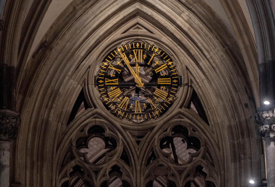 A clock is pictured inside the Cologne Cathedral in Cologne, Germany, Wednesday, Nov. 30, 2022. An unprecedented crisis of confidence is shaking the Archdiocese of Cologne. Catholic believers have protested their deeply divisive bishop and are leaving in droves over allegations that he may have covered up clergy sexual abuse reports. (AP Photo/Michael Probst)